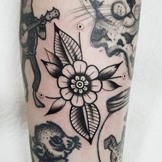 a close up of a person's leg with tattoos on it and an animal