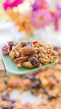 a spoon full of nuts and raisins on a green plate