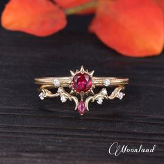 a close up of a ring on a wooden surface with flowers in the back ground