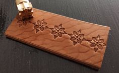 a piece of wood that has some flowers on it