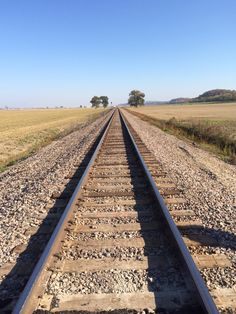 an empty train track in the middle of nowhere