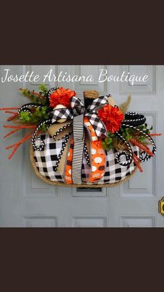 the front door is decorated with an orange and black bow