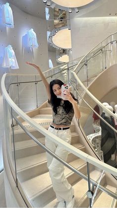 a woman taking a selfie while standing on some stairs