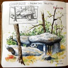 an open book with watercolor and ink drawings on it, featuring a stone bench in the woods