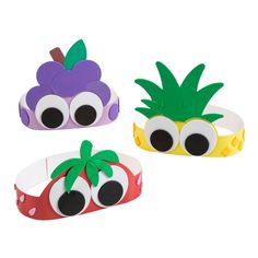 three bracelets made to look like fruit with googly eyes and one has a pineapple on it