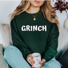 Our comfortable and cozy shirts are perfect for the Christmas & holiday season!  Cute and minimal outfit or pajama top, for cold winter nights by the fireplace.  Treat yourself to a gift or buy for a friend or family member.   GRINCH text can be customized with any of the following colors - White, Black, Gold, Red & Green.  Please enter your selection in the personalization box.  Handmade - we design, hand press, and ship everything from our studio in NY ❤️ Design is applied using heat transfer Grinch Outfit, Morning Pancakes, Mom Brain, Holiday Pajamas, Minimal Outfit, Friends Mom, Mom Sweatshirt, Saturday Morning, Fitted Sweater