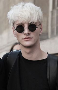 a man with white hair and black sunglasses