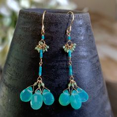 "Wire: 14k Yellow Gold Earring Length: Approx. 1 1/2\" Stones: Chrysoprase Drops (approx. 6mm/7mm size), Turquoise (approx. 3mm sizes) Beads: Antique Italian Glass (Approx. 1/2mm size) Listed is a handmade 14k Yellow Gold Wire Earring with Chrysoprase Drops, Turquoise Nuggets and Antique Italian Glass Beads. -------------------------------------------------- Let me know if you have any questions! *Made to order (allow 5-7 days) *Allow 7-10 days for shipping (FedEx) About Debbie De la Cueva Jewel Turquoise Dangle Earrings With Amazonite, Turquoise Amazonite Dangle Earrings, Handmade Turquoise Chrysoprase Earrings, Turquoise Jade Earrings With Natural Stones, Wire Earring, Yellow Gold Earrings, Gold Bracelet Chain, Gold Earring, Yellow Gold Earring