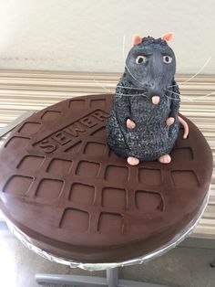 a cake shaped like a rat sitting on top of a table