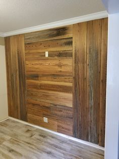 an empty room with wood paneling on the walls