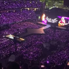 the stage is lit up with purple lights