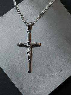 Our classic stainless steel cross necklace now comes in silver! Made from premium quality 316L stainless steel. This necklace is tarnish & fade resistant, and can be worn in the shower. Stainless steel jewelry is a great choice for men as it is durable and hypoallergenic, which makes it suitable for those with sensitive skin. Dimensions Length: 18", 20", 22" Chain: 3 mm curb Cross: 28 mm x 48 mm Hypoallergenic Tarnish Resistant Water Proof Recommended length for men with an average medium build Minimalist Silver Stainless Steel Cross Necklace, Silver Stainless Steel Cross Necklace For Gift, Silver Stainless Steel Cross Necklace As Gift, Stainless Steel Crucifix Cross Necklace As Gift, Silver Stainless Steel Cross Necklace, Silver Crucifix Necklace With Polished Finish, Stainless Steel Crucifix Necklace With Silver Chain, Nickel-free Stainless Steel Crucifix Necklaces, Silver Crucifix Stainless Steel Jewelry