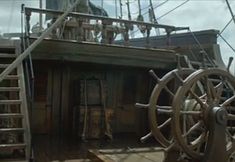 the steering wheel and deck of a large ship