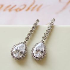 Tiny Vintage Style Bridal Earrings, Art Deco Earrings, Wedding Earrings Tiny  vintage style zircon  earrings  Colour: rhodium(silver tone) /clear Measurements: approx 3.6 cm x 1cm .  Materials:  rhodium components, zircon crystals . Stud earrings. Great for wedding or other celebration. MORE SAME STYLE: https://www.etsy.com/uk/shop/BridalArtDeco?ref=listing-shop-header-item-count&section_id=23918122 Please note some images have been enlarged to allow for details to be shown. Read the descriptions for details on actual size of each item.In all my shop listing I have made every effort to ensure that the images match the item as closely as possible! However, colours do vary on different monitors.  Thank you for visiting / shopping ! Wedding Halo Drop Diamond Earrings, Wedding Drop Diamond Earrings With Halo Design, Wedding Halo Design Drop Diamond Earrings, Bridal Drop Earrings With Halo Design, Halo Design Bridal Drop Earrings, Elegant Drop Diamond Earrings For Wedding, White Teardrop Earrings With Prong Setting For Wedding, Elegant Pear-shaped Diamond Earrings For Wedding, Cubic Zirconia Bridal Earrings With Halo Design For Wedding