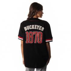 Upgrade your traditional jersey with our new Ohio Button Up Baseball Shirt. With intricate detailing and stitching, each jersey showcases signature Buckeyes branding and colorways for a bold look on game day. Cotton and breathable fabric Ribbed trims Button closures Stitched motifs Material: 55% Polyester 45% Cotton Care: Wash on delicate cycle Tumble dry low Do not bleach Do not iron Black Cotton Baseball Jersey For Fan Gear, Black Cotton Baseball Jersey For Game Day, Black Cotton Jersey For Fan Gear, Black Baseball Collar Top For Sports Fans, Collegiate College Jersey With Team Logo, Collegiate Jersey With Team Logo For College, College Cotton Jersey With Team Logo, Game Day Cotton Baseball Jersey With Team Logo, Collegiate Jersey T-shirt With Baseball Collar