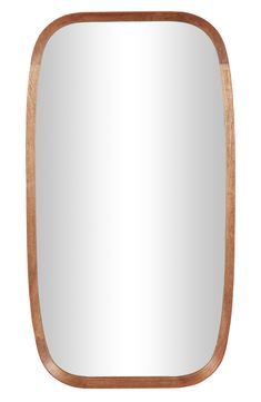 a wooden frame mirror sitting on top of a white wall