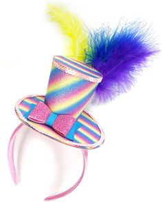 a colorful hat with a purple bow and a rainbow feather on the top, sitting on a pink headband