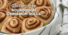 a bowl filled with cinnamon rolls on top of a table