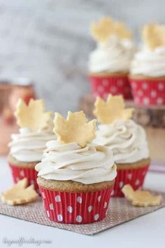 cupcakes with vanilla buttercream frosting and maple leaf decorations on top