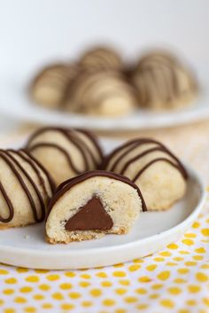 chocolate covered cookies on a plate with one cut in half