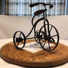 a wooden and metal bicycle on display in front of a window