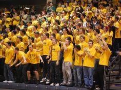 a group of young people standing on top of a basketball court next to each other