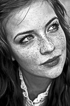 a pencil drawing of a woman with freckles on her face and neckline