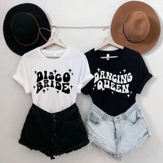 two t - shirts with the word lil on them hanging from a clothes line next to a hat