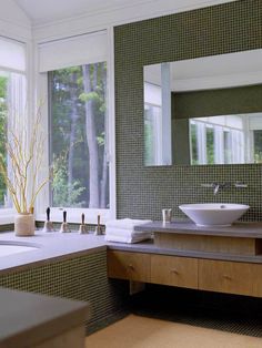 a large bathroom with two sinks and mirrors