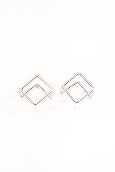 The Gaia Geometric Hoop is a unique earring that provides a new take on a classic design. The intentional avant-garde design is intended to show off your beauty from all dimensions. While this may sound like your average minimalistic earring, the irregular cube shape makes it stand out and perfect for every occasion. Similar to many of our other pieces, this earring is designed to make a subtle statement. Offered in both silver and gold, the geometric shapes offer a touch of glow and will transf Modern Cartilage Earrings With Ear Wire, Modern Metal Cartilage Earrings As Gift, Modern Metal Cartilage Earrings For Gifts, Modern Geometric Single Hoop Earring, Modern Geometric Hoop Earrings As Gift, Modern Geometric Hoop Earrings For Gift, Minimalist Geometric Earrings For Party, Minimalist Small Hoop Earrings For Party, Minimalist Nickel-free Hoop Earrings For Party