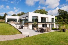 a modern house with an outdoor dining area