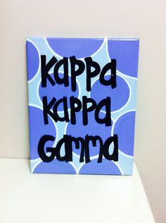 a blue and white sign that says kappa kappa gama on it