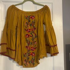 Gold Color Off Shoulder Top With Beautiful Embroidery Down Center. Bell Sleeves With Embroidered Piping Size Medium Flowy Long Sleeve Top, Blouse With Bell Sleeves, Pipe Sizes, Off Shoulder Top, Off The Shoulder Top, Beautiful Embroidery, Off Shoulder Tops, Red Yellow, Off Shoulder Blouse