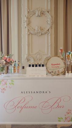 a table with flowers and perfume bottles on it