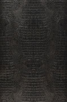 an image of a black leather textured surface that looks like it has been used as a background