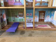 a doll house with furniture and accessories inside