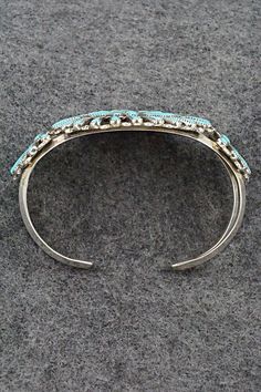 This turquoise and sterling silver bracelet was made by Zuni silversmith Carlos Tsipa. The inside of the cuff is signed C. Tspia.Size: 5 5/8" (will fit up to a 6 1/2" wrist)Gap: 7/8"Width: 2"Free shipping on all orders! We ship with USPS and always include tracking. All orders ship within a day of payment.Returns are accepted up to 30 days after you receive your order. Just send us a message. Our shop offers cash back or store credit. The item must be returned in new condition. Bear Carving, Pearl Chain, Sterling Silver Bracelet, Native American Jewelry, Turquoise Sterling Silver, Free Jewelry, Sterling Silver Bracelets, Jewelry Gifts, Silver Bracelet