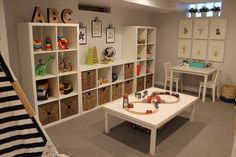 a child's playroom with toys and bookshelves