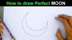 someone is drawing a moon on paper with pencils