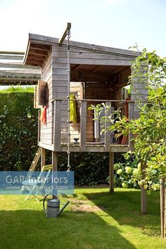 a small wooden tree house in the garden