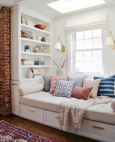 a living room filled with lots of white furniture