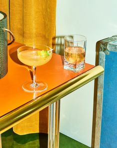 an orange table with two glasses on it