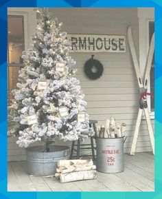 a white christmas tree sitting on top of a wooden floor next to two buckets