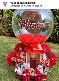 a large gum ball filled with candy and candies on top of a grass covered field