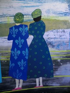 two women in blue dresses looking out at the ocean