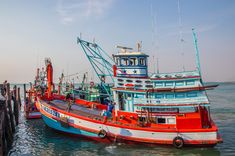 several boats in the water near each other