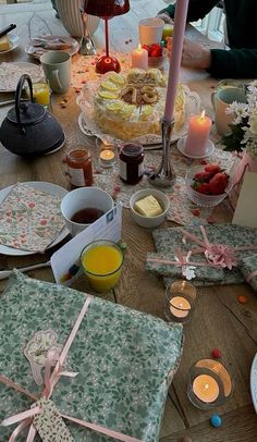 a table topped with lots of food and candles