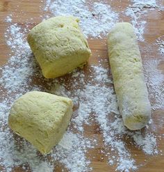 three uncooked doughs sitting on top of a cutting board covered in powdered sugar