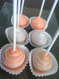 four chocolate covered cake pops sitting on top of each other with white candles sticking out of them