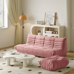 a living room with a pink couch and coffee table